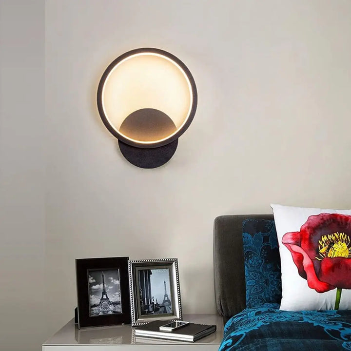 Front view of modern Lumen Ring wall light showcasing its sleek circular design and soft glow.