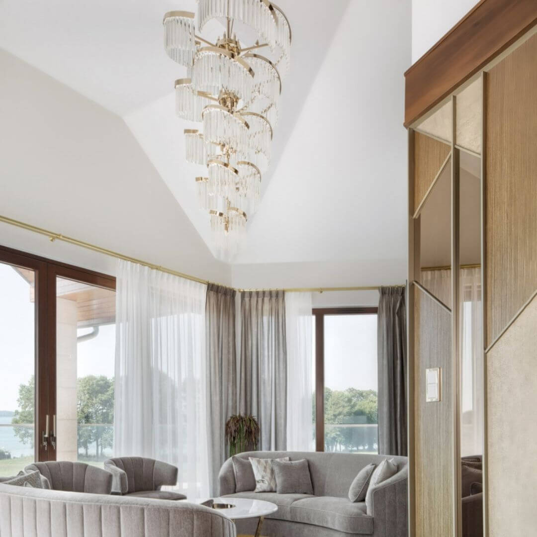 Luminary Glass Chandelier Light in the living room, enhancing the space with its modern white-painted design and soft, ambient illumination from elegant glass shades.