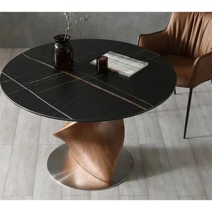 Luxury round dining table with black marble top and sculptural wood base – top angle view