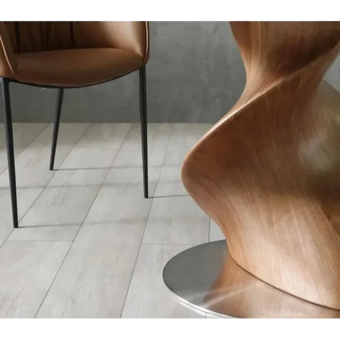 Luxury round dining table with black marble top and sculptural wood base – close-up view
