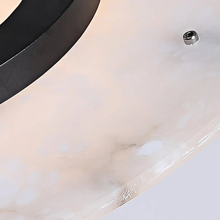 Close-up of Magma pendant lamp showing natural marble discs and matte black metal frame