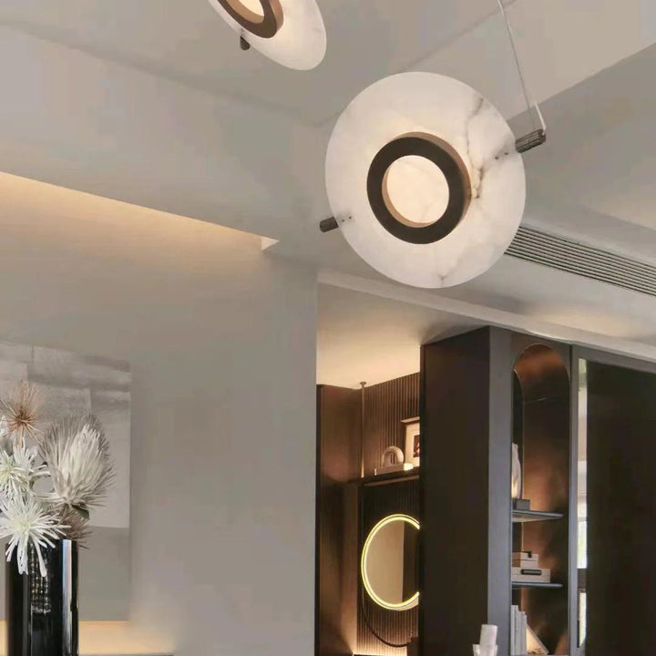 Magma pendant lamp in living room with black exterior and glowing gold interior, modern lighting