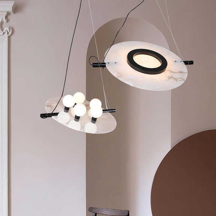 Hanging view of Magma pendant lamp with black exterior and radiant gold interior, modern lighting