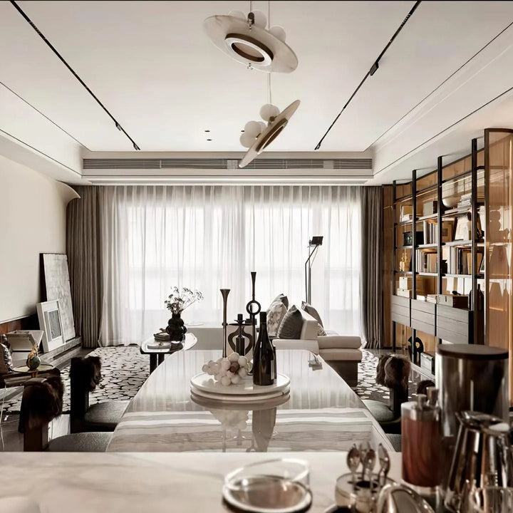 Front view of Magma pendant lamp with black exterior and glowing gold fiber interior, modern lighting