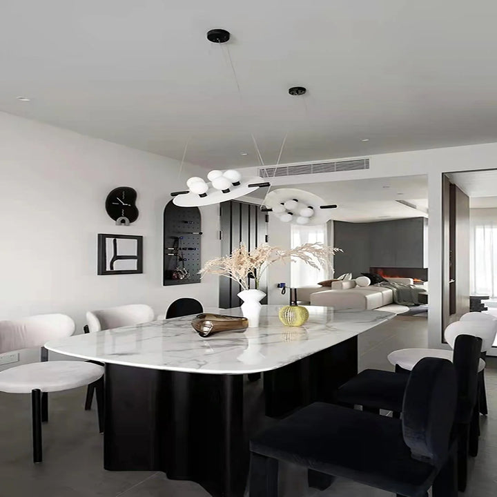 Luxury Magma pendant lamp over dining table with black exterior and glowing gold interior