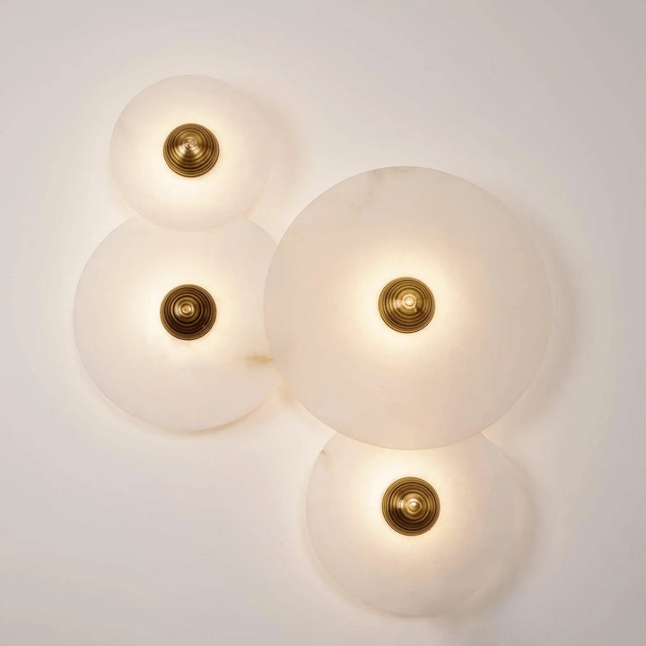 Nayra round alabaster wall lamp, modern lighting, front view, available in four sizes