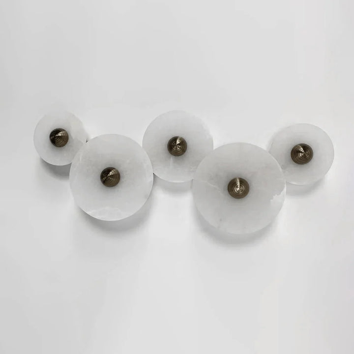 Nayra round alabaster wall lamp, modern lighting, front view, five sizes