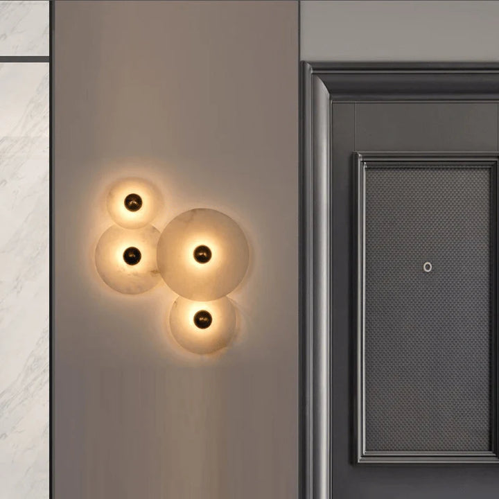 Nayra round alabaster wall lamp, modern lighting, front view, four sizes