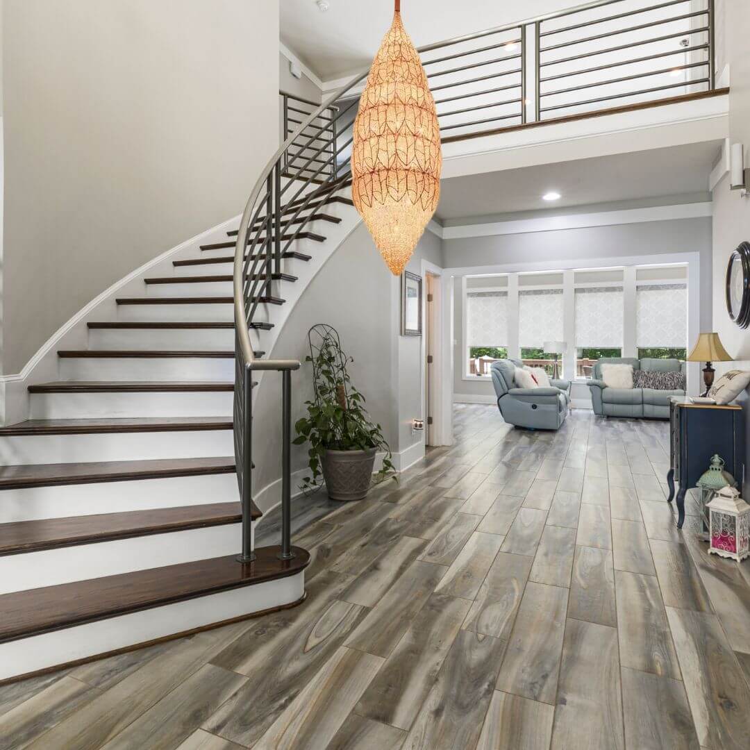 Neon oval-shaped chandelier light hanging beside staircase, adding modern style and vibrant illumination