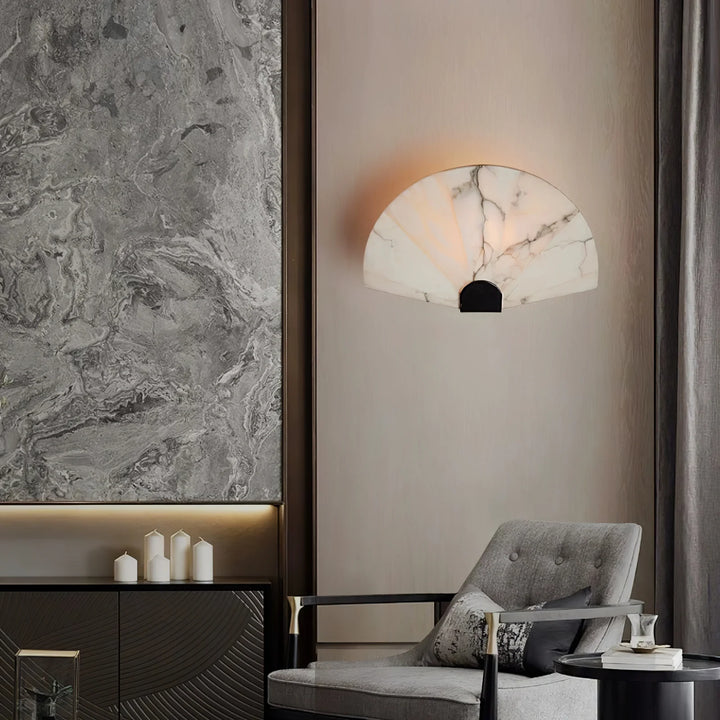 Nevora alabaster wall lamp on living room wall with gold metal accents, modern elegant lighting