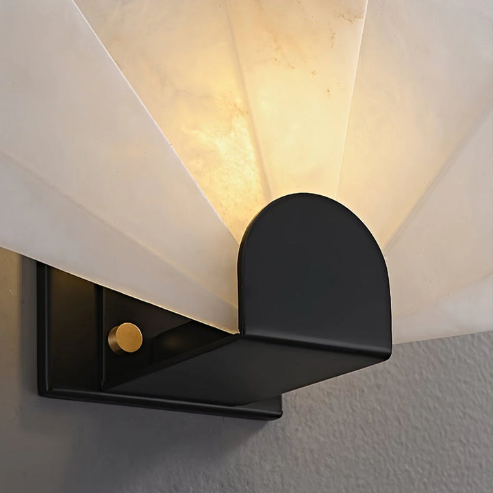 Nevora alabaster wall lamp close-up showing metal and wall mount details with elegant design accents