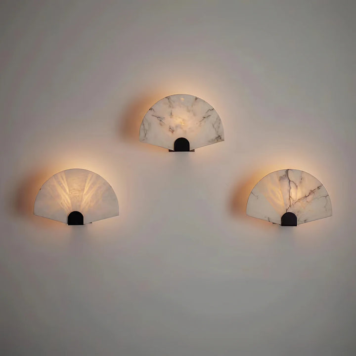 Nevora alabaster wall lamp front view with gold metal accents, modern elegant lighting fixture