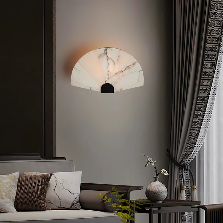 Nevora alabaster wall lamp front view in living room with gold metal accents, modern elegant lighting
