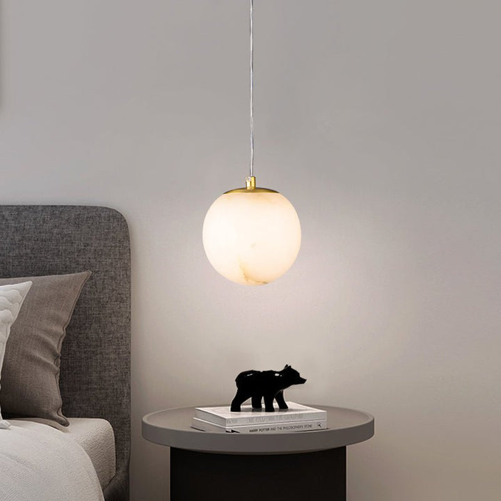 Nordic Gold Pendant Light placed bedside – Elegant lighting solution with a luxurious gold finish, perfect for enhancing bedroom ambiance. 