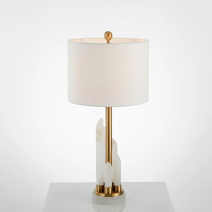 Front view of Orbit metal table lamp with metal and natural stone base, soft warm LED light