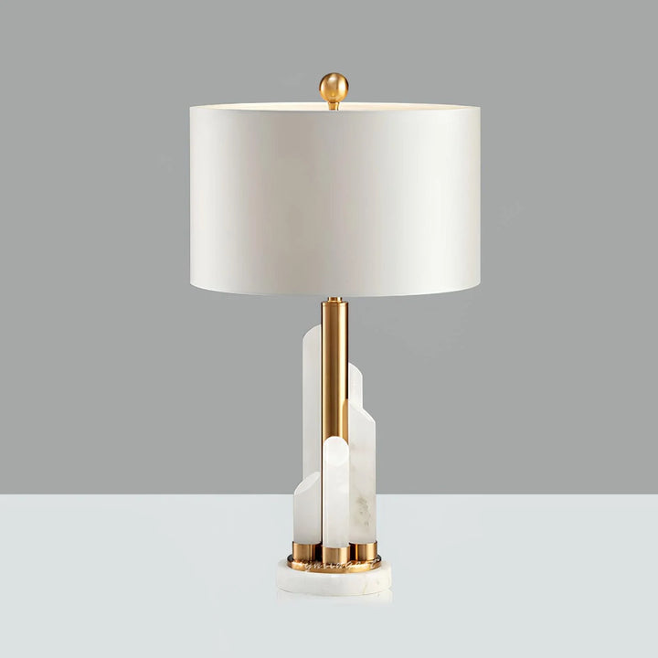 Front view of Orbit metal table lamp with brass finish and natural stone base, warm LED light