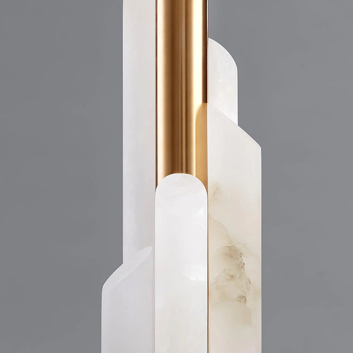 Close-up of Orbit metal table lamp showing polished marble base and sleek brass metal stand