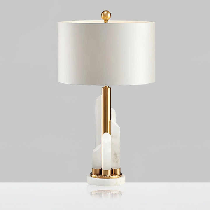 Front view of Orbit metal table lamp with brass finish, natural marble base, and warm LED light