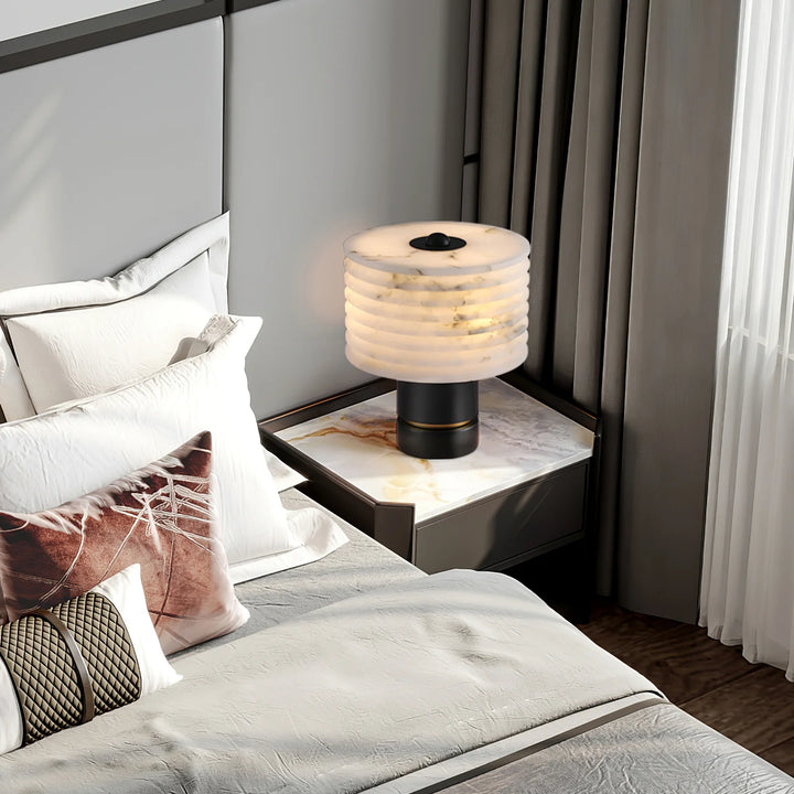 Outela table lamp on bedside table, modern design providing warm ambient lighting for bedrooms