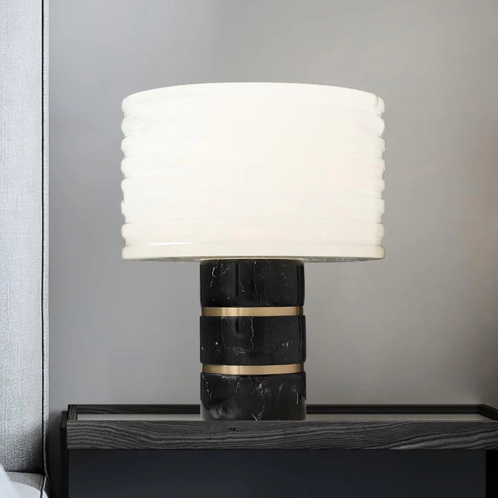 Front view of Outela table lamp, featuring modern design with warm ambient lighting for stylish interiors