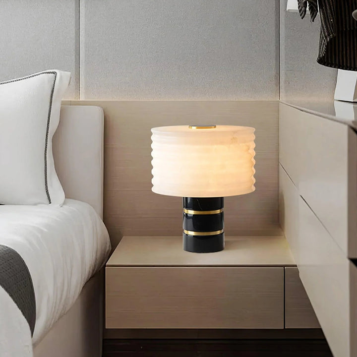Outela table lamp on bedside table, showcasing modern design with warm ambient lighting for interiors