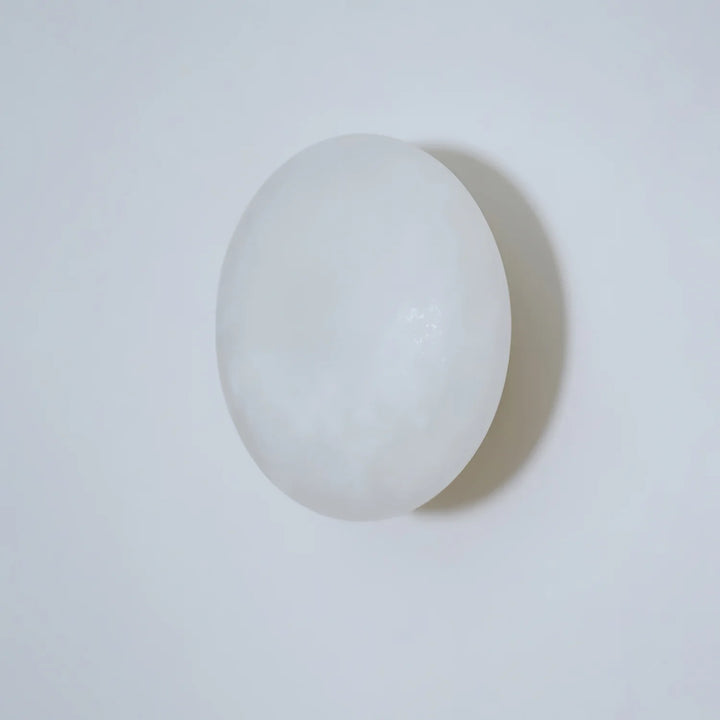 Pebble alabaster wall light side view, elegant marble design for modern home or restaurant interiors