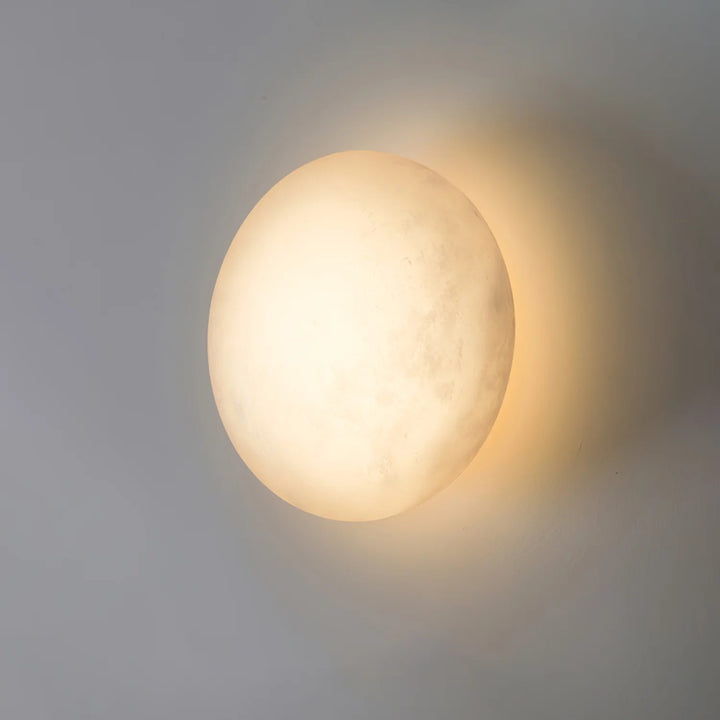 Pebble alabaster wall light front view, elegant marble finish for modern home interior lighting