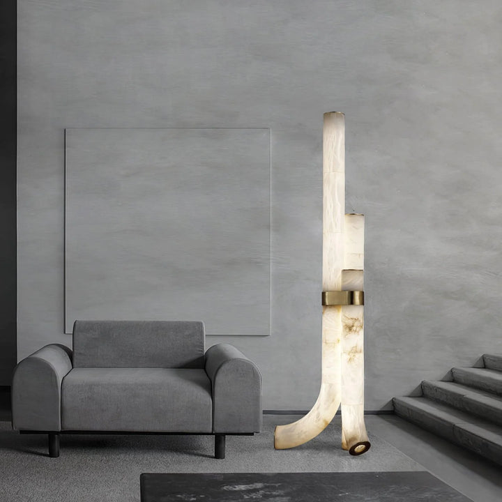 Piped alabaster floor lamp beside stairs, modern design providing warm ambient lighting for interiors