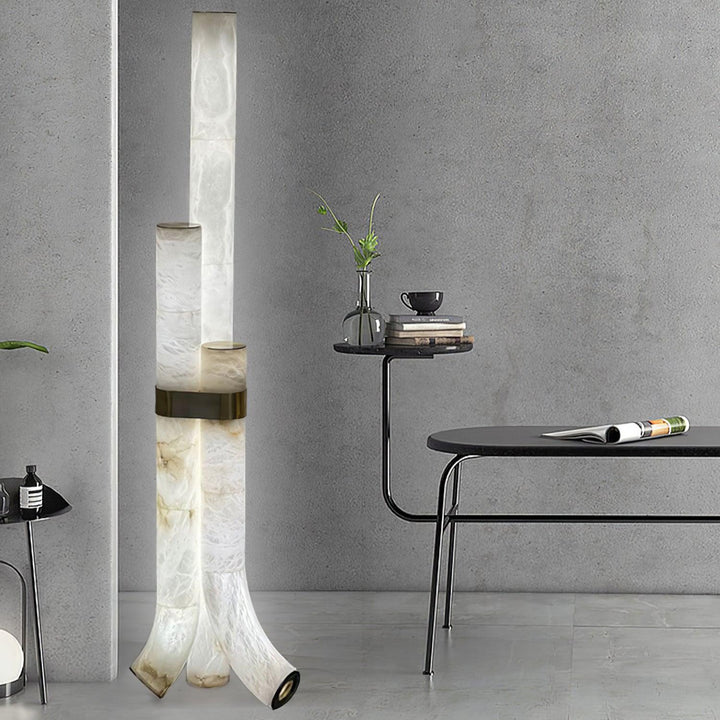 Modern piped alabaster floor lamp with brass accents, offering warm ambient light for stylish interiors