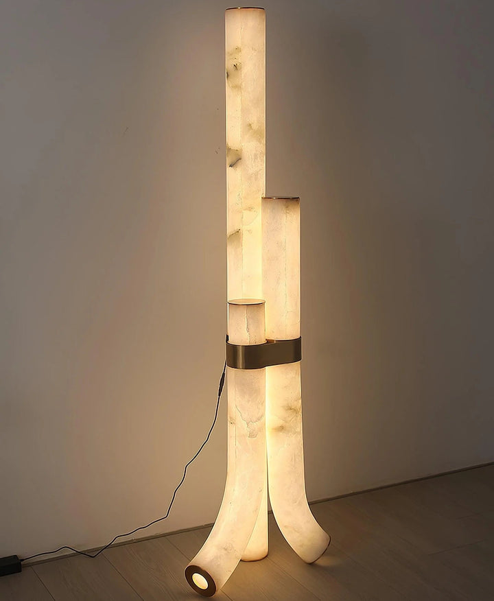 Front view of piped alabaster floor lamp turned on, highlighting warm glow and modern sleek design