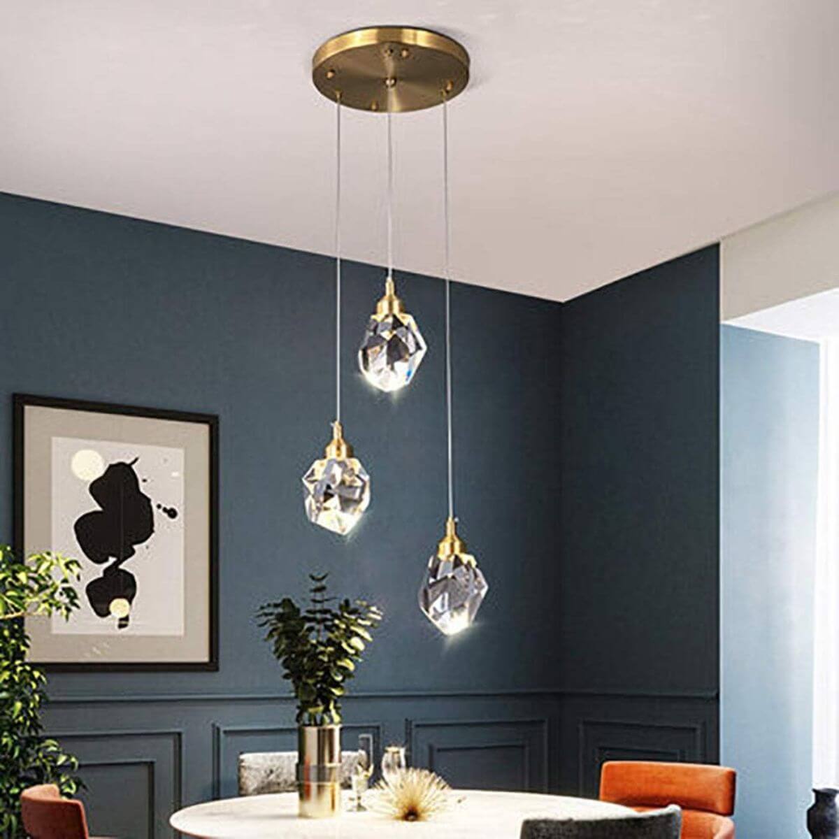 Pulsate 3-head LED crystal chandelier hanging in dining room, adding modern elegance and radiant lighting
