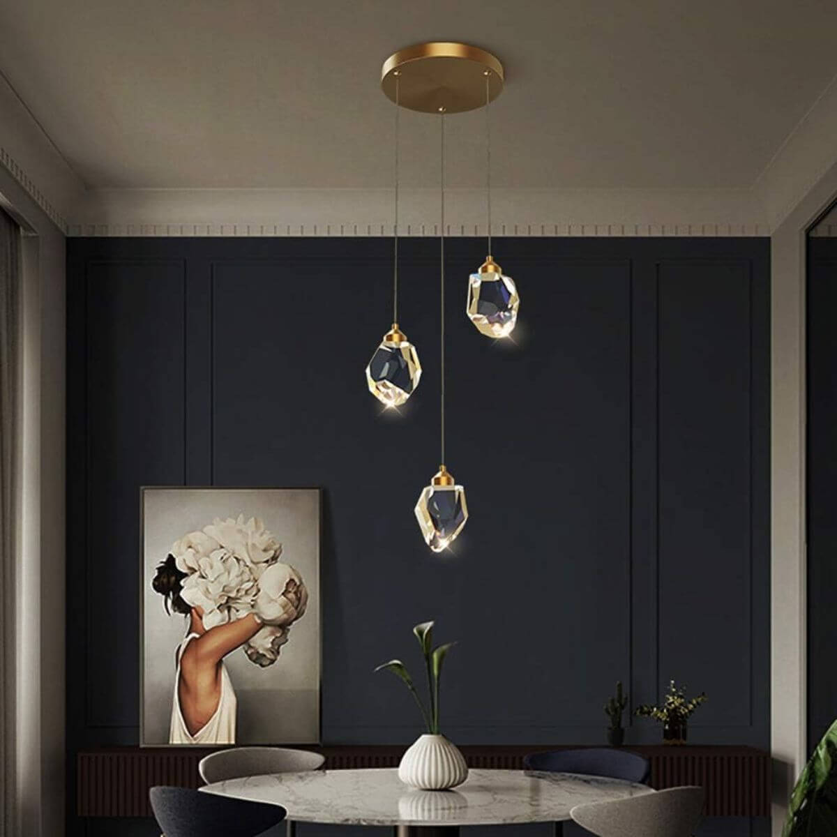 Pulsate 3-head LED crystal chandelier light hanging above dining table, creating elegant and ambient lighting