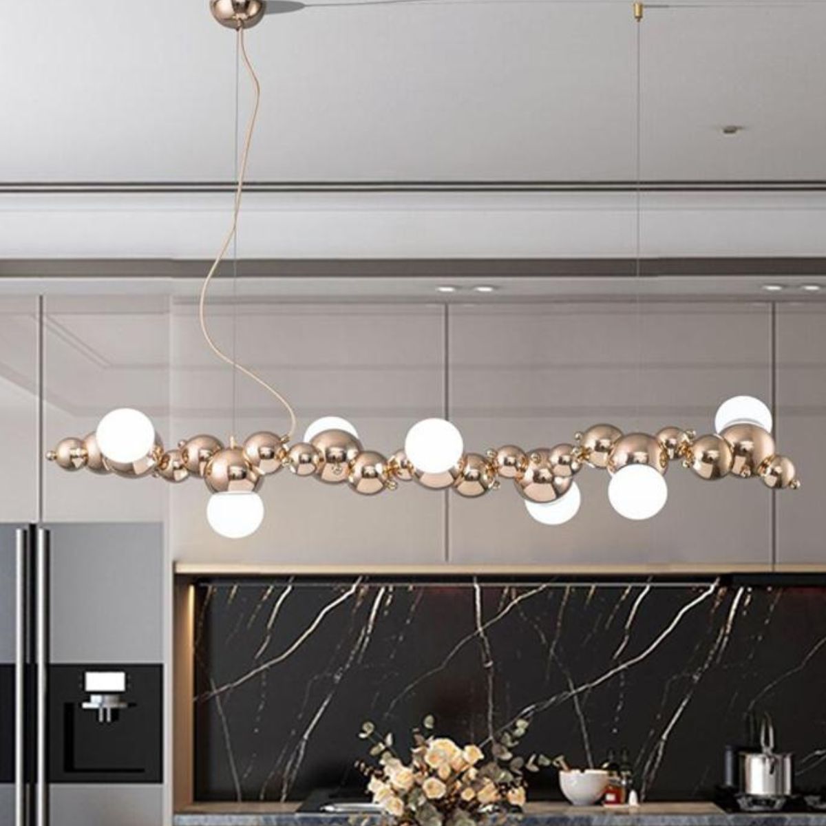 Radiance chandelier light fixture installed above kitchen island, providing elegant and functional lighting for dining and cooking areas