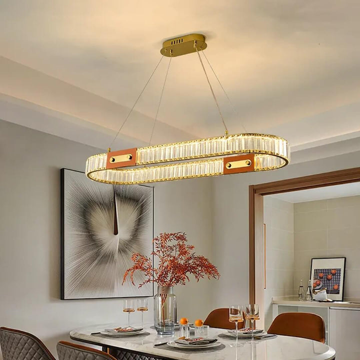 Rectangular crystal chandelier suspended above kitchen island, showcasing modern elegance and sparkling crystals