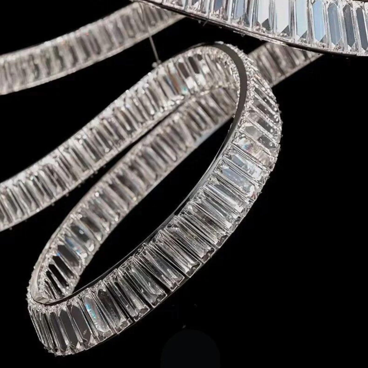 Close-up detail of reflected chandelier light crystals, showcasing sparkling facets and intricate craftsmanship