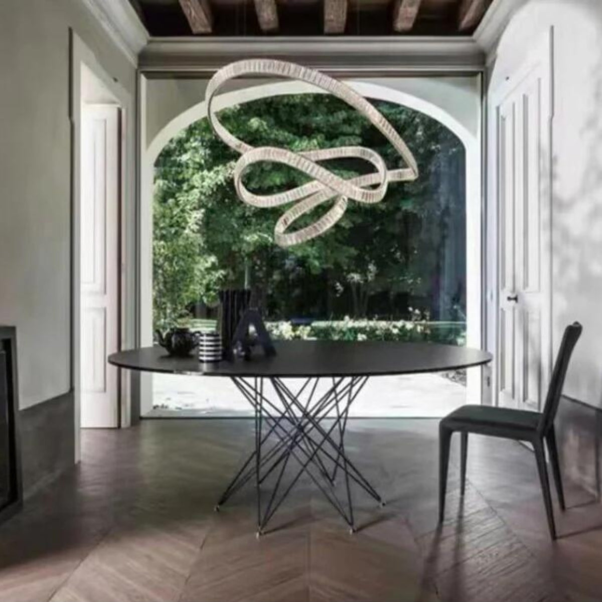 Reflected chandelier light above dining table in Australia, enhancing the space with shimmering elegance and modern charm