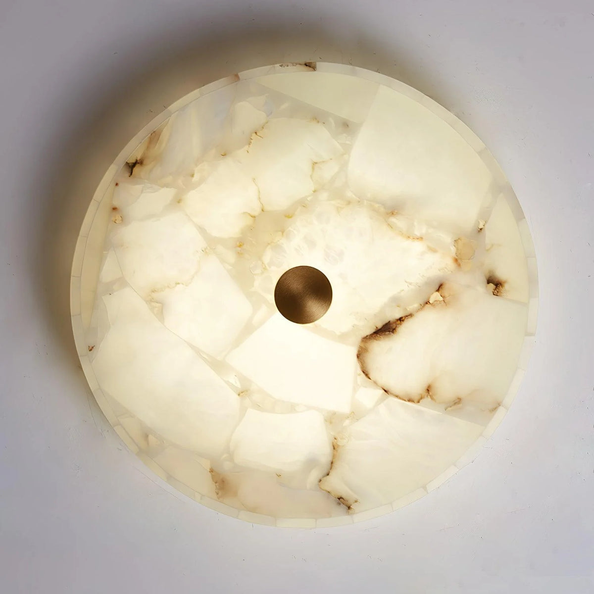 Round alabaster ceiling lamp from below view, modern lighting decor for stylish interiors