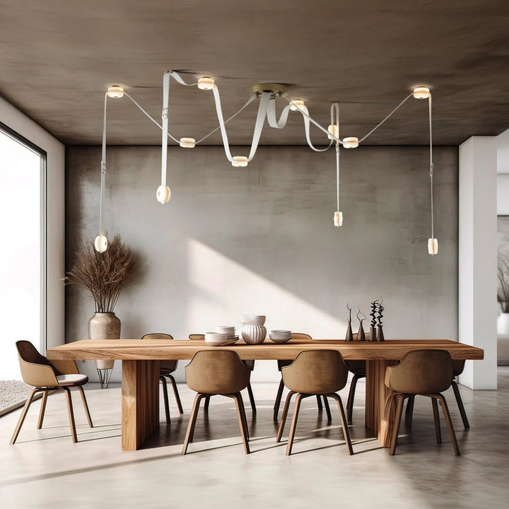 Snaps alabaster pendant light above dining table with gold metal accents, modern elegant lighting fixture