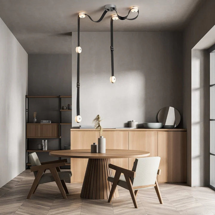 Snaps alabaster pendant light front view in living room with gold metal accents, modern elegant design