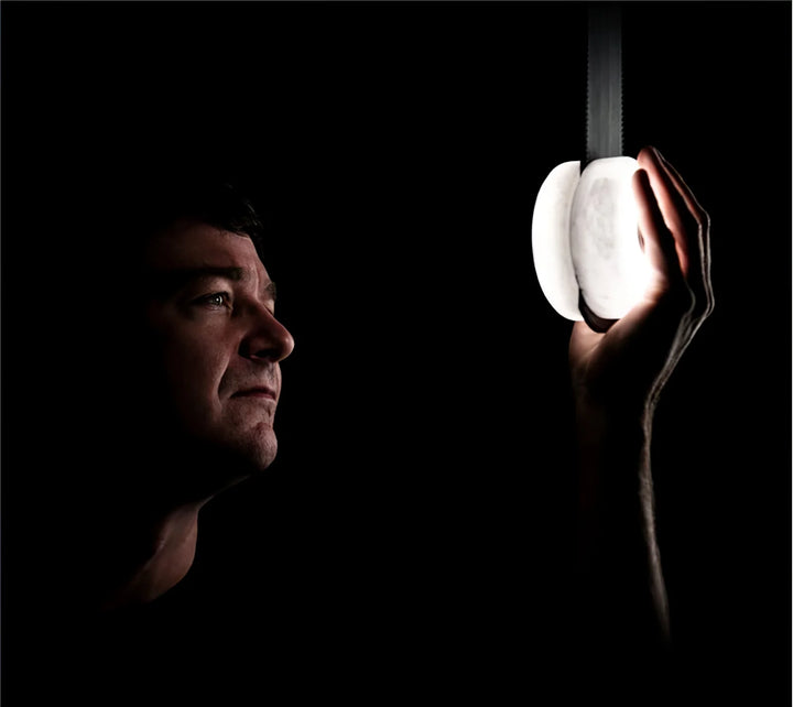 Snaps alabaster pendant light with a man holding marble, modern decorative hanging lighting