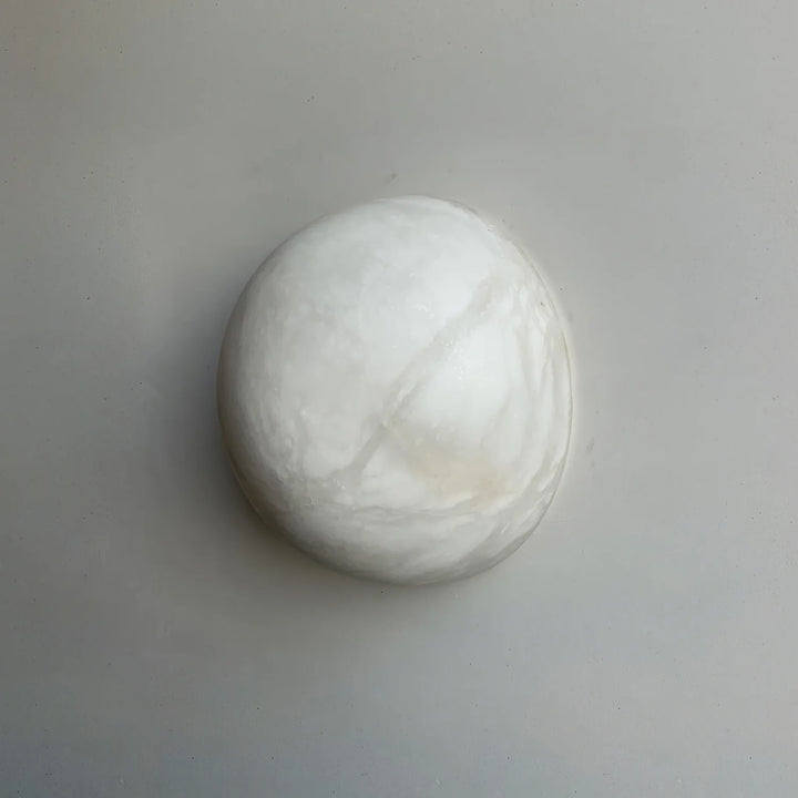 Front view of Spanish alabaster snowflake wall sconce for modern home lighting décor