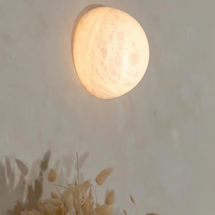 Front view of Spanish alabaster snowflake wall sconce for elegant home lighting