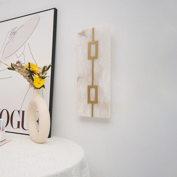 Side view of square alabaster wall lamp, showcasing luxury design and warm ambient lighting