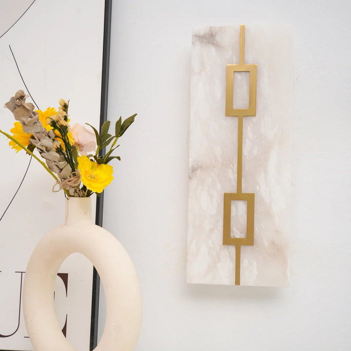 Front view of square alabaster wall lamp, showcasing luxury design and warm ambient lighting