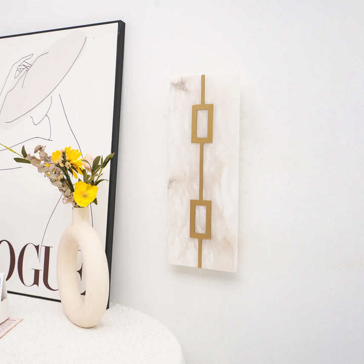 Side view of square alabaster wall lamp, showcasing luxury design with warm ambient lighting