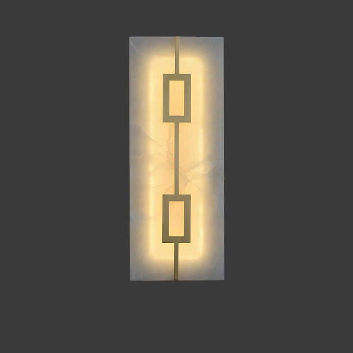 Front view of square alabaster wall lamp turned on, featuring luxury design and warm ambient lighting