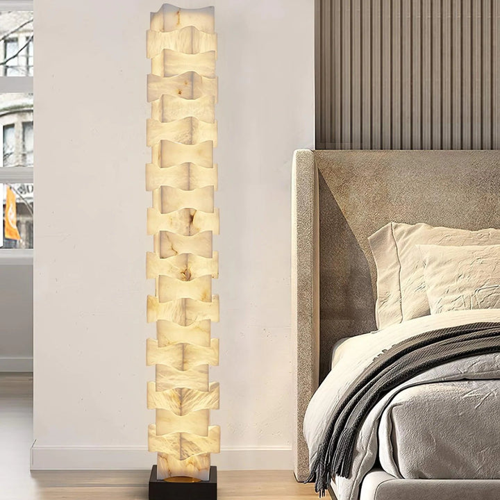 Bedside view of stacked alabaster squares floor lamp, modern elegant lighting fixture for bedroom décor