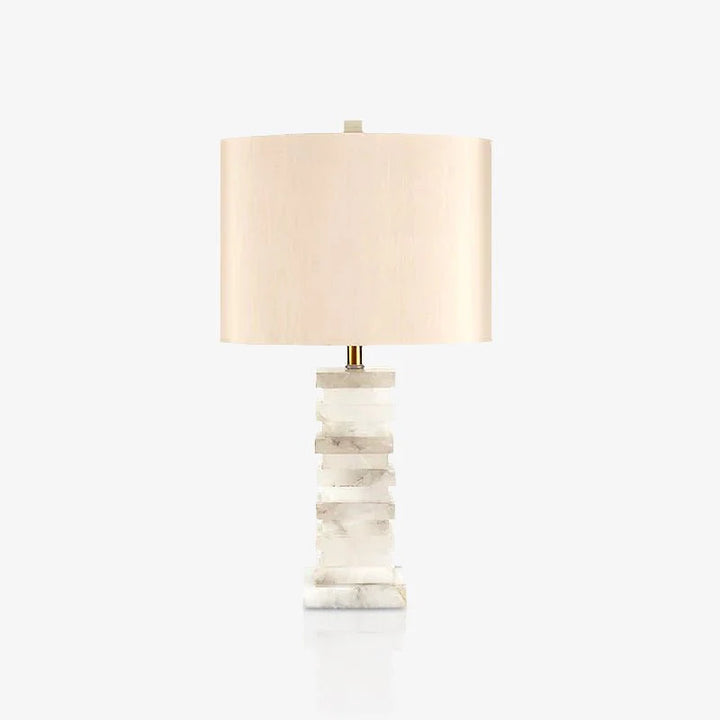 Front view of stacked alabaster table lamp with layered stone base and linen shade, modern lighting