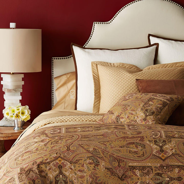 Front bedside view of stacked alabaster table lamp with layered stone base and linen shade