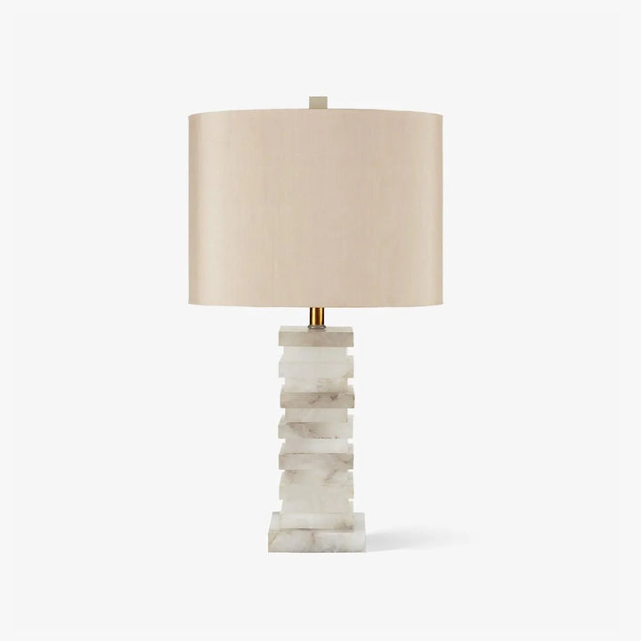 Front view of stacked alabaster table lamp with layered stone base and linen shade, modern lighting